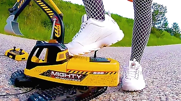 Big excavator is destroyed kicked, toycrush, plastic car, jumps , smashes car, trample, trampled, crushed, smashed, crushed, broken plastic car, crush toy car, sneaker , toy, toycrush, plastic car, jumps , smashes car, trample