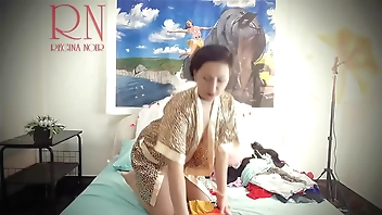 Housewife laid out sexy lingerie and outfits on the bed. She tries on panties, corsets, bras, socks, stockings, tights, peignoir. 1