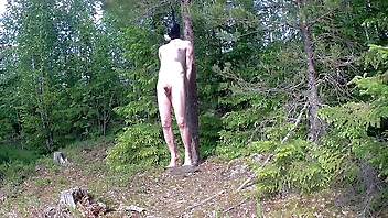 Balancing on a rock in the woods.